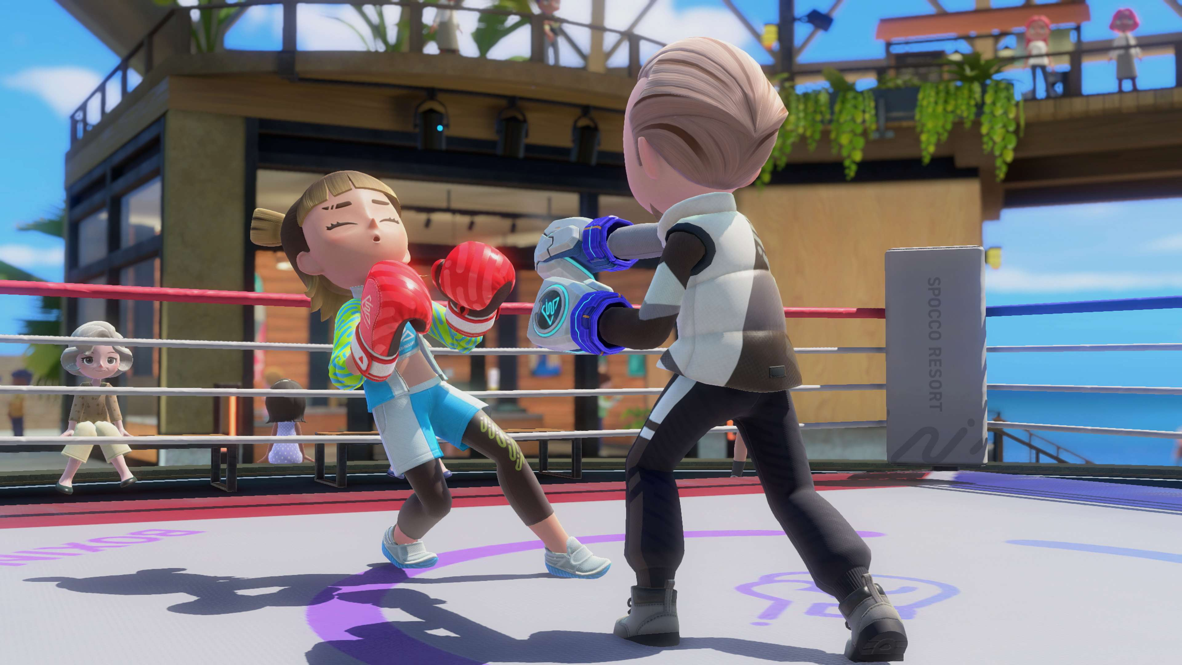 Zwei animierte Charaktere kämpfen mit Boxhandschuhen im Ring eines sonnigen Resorts.