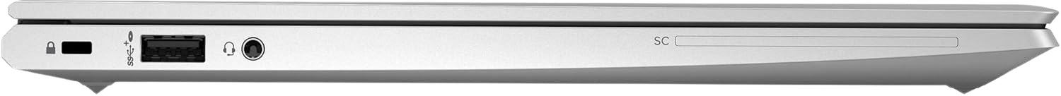 Vista lateral de un portátil plateado con puertos USB, de audio y de seguridad.