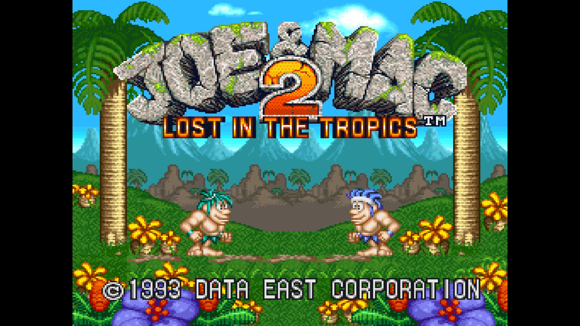 Pantalla de título de Joe y Mac 2 Lost in the Tropics con dos cavernícolas, palmeras y montañas.