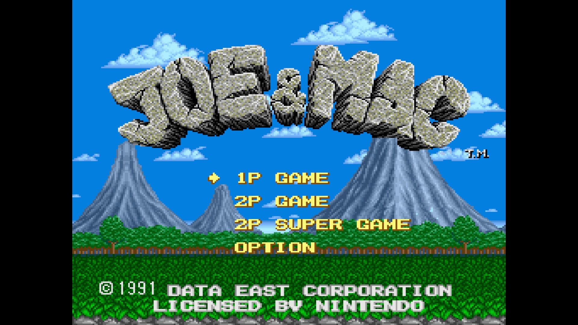 Pantalla de título del videojuego Joe y Mac frente a un paisaje de selva montañosa.