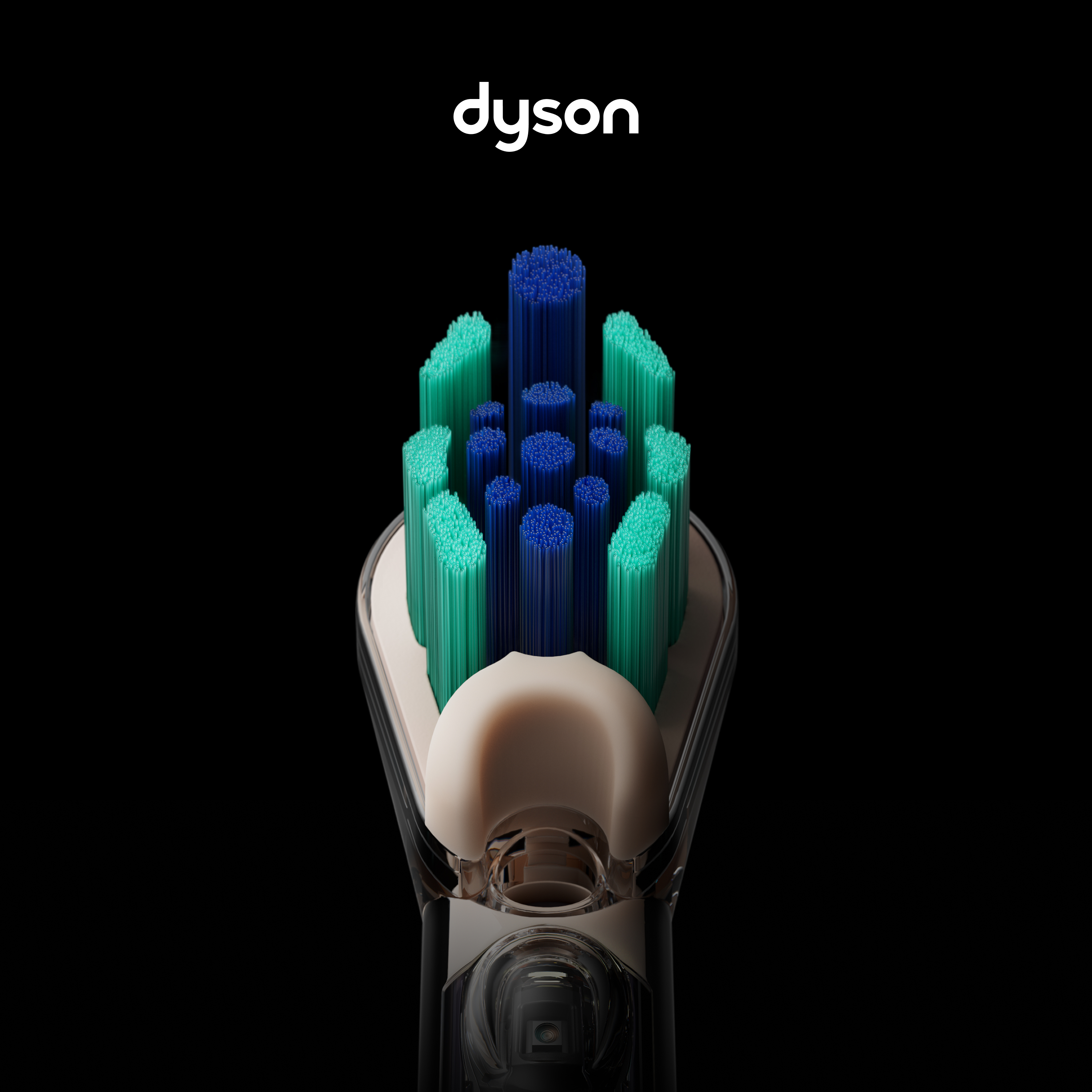 Nahaufnahme eines Dyson-Zahnbürstenkopfes mit grünen und blauen Borsten auf schwarzem Hintergrund.