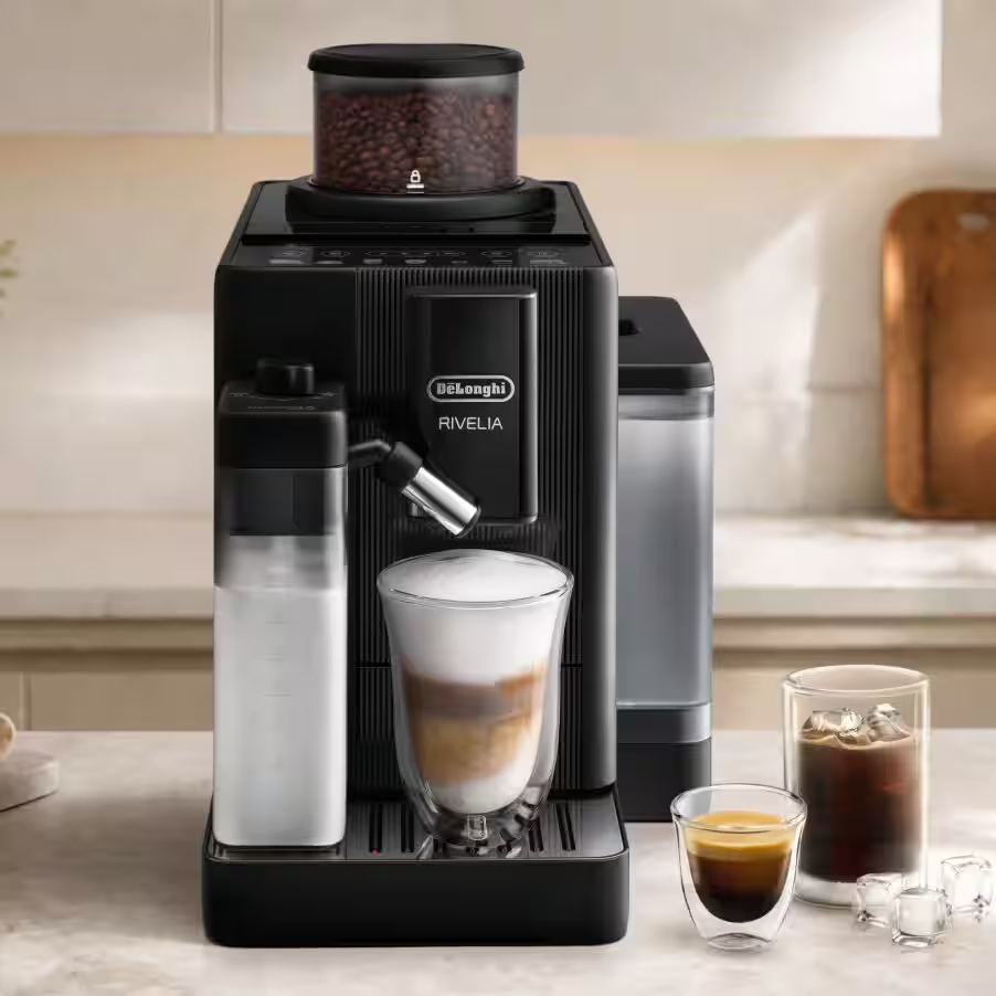 Fekete DeLonghi Rivelia kávéfőző konyhapulton tejkiöntővel és poharakkal.