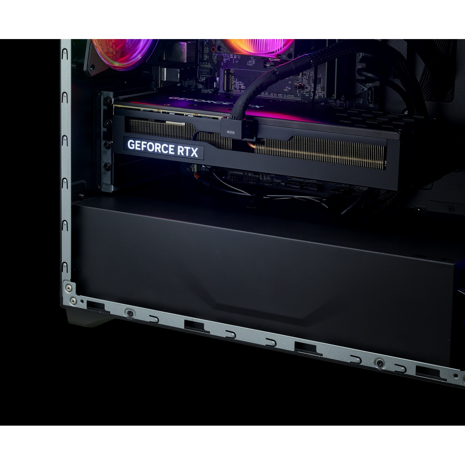A detailed view of a GeForce RTX graphics card installed inside a desktop PC with colorful lighting.