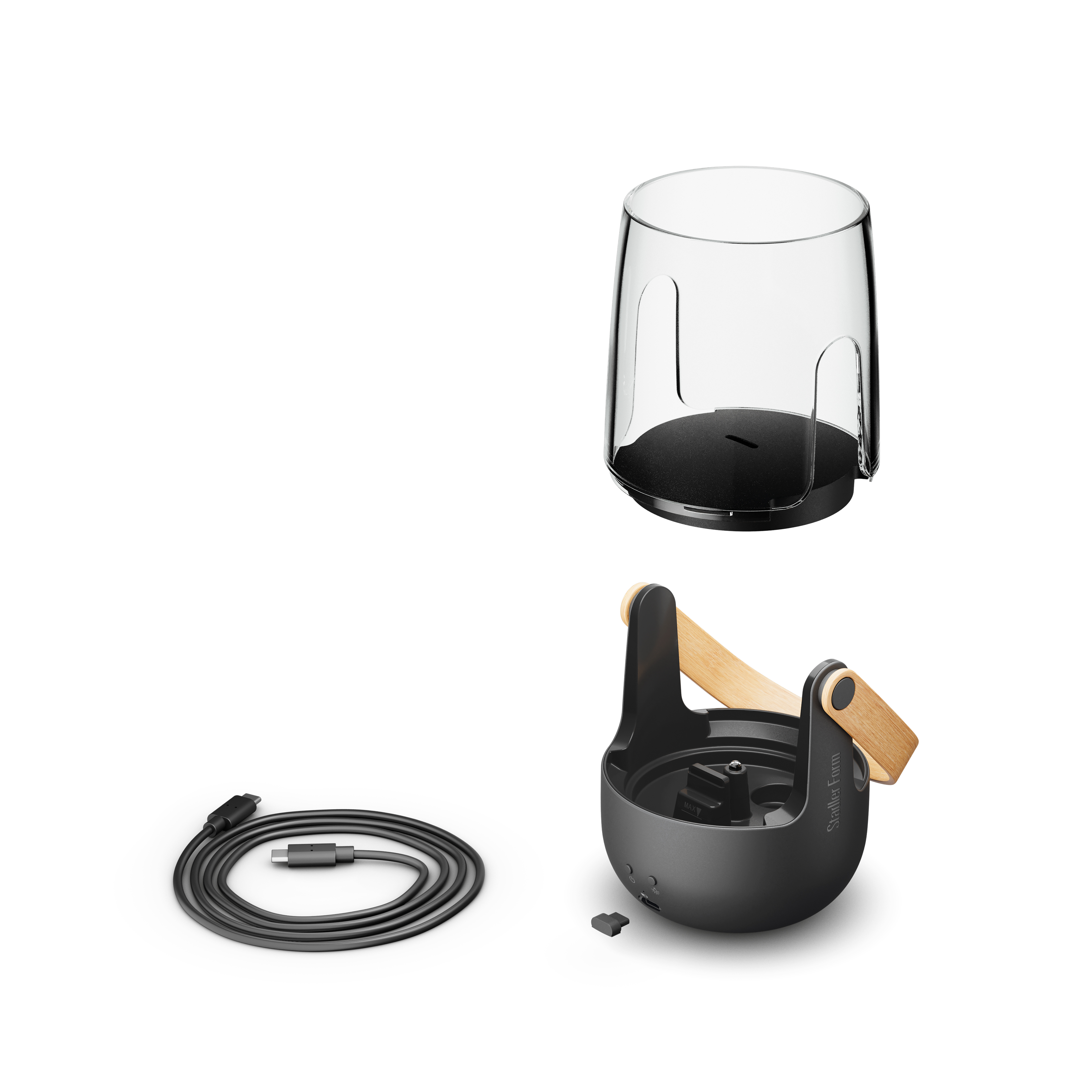 Zerlegtes Gerät mit Glasoberteil, dunklem Sockel mit Holzgriff und aufgerolltem schwarzen USB-C-Kabel.