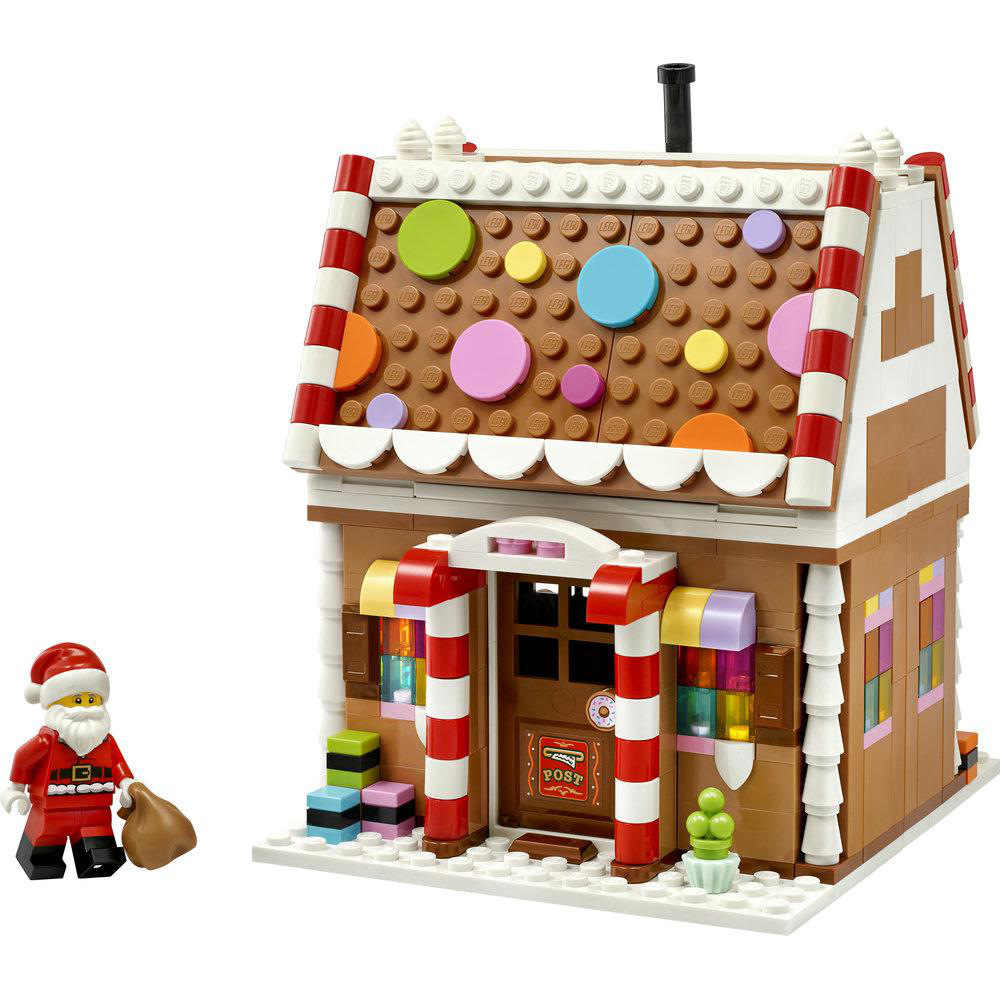 Ein Lego-Lebkuchenhaus mit bunten Verzierungen und einer Weihnachtsmann-Figur davor.