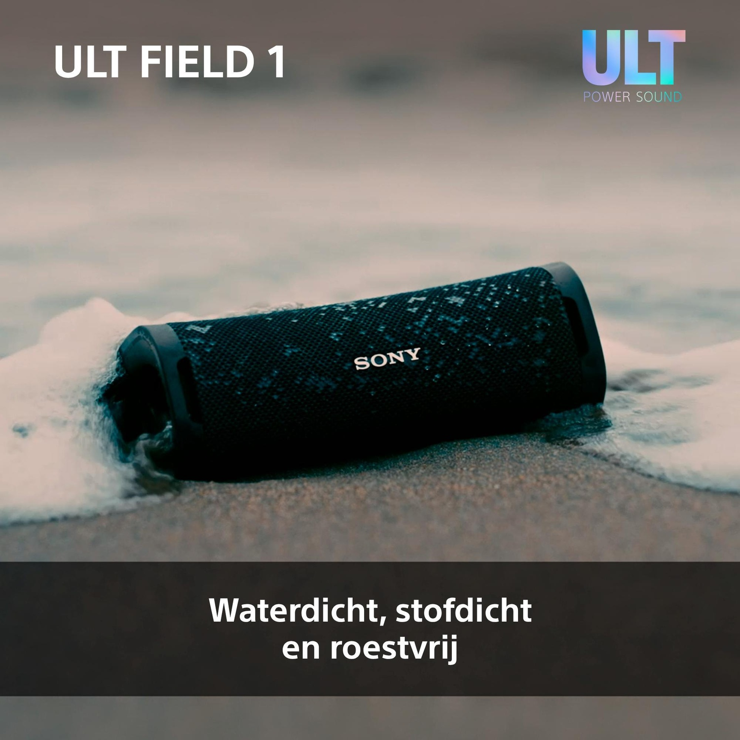 A black, water-resistant Sony speaker rests on a wet beach amidst sea foam.