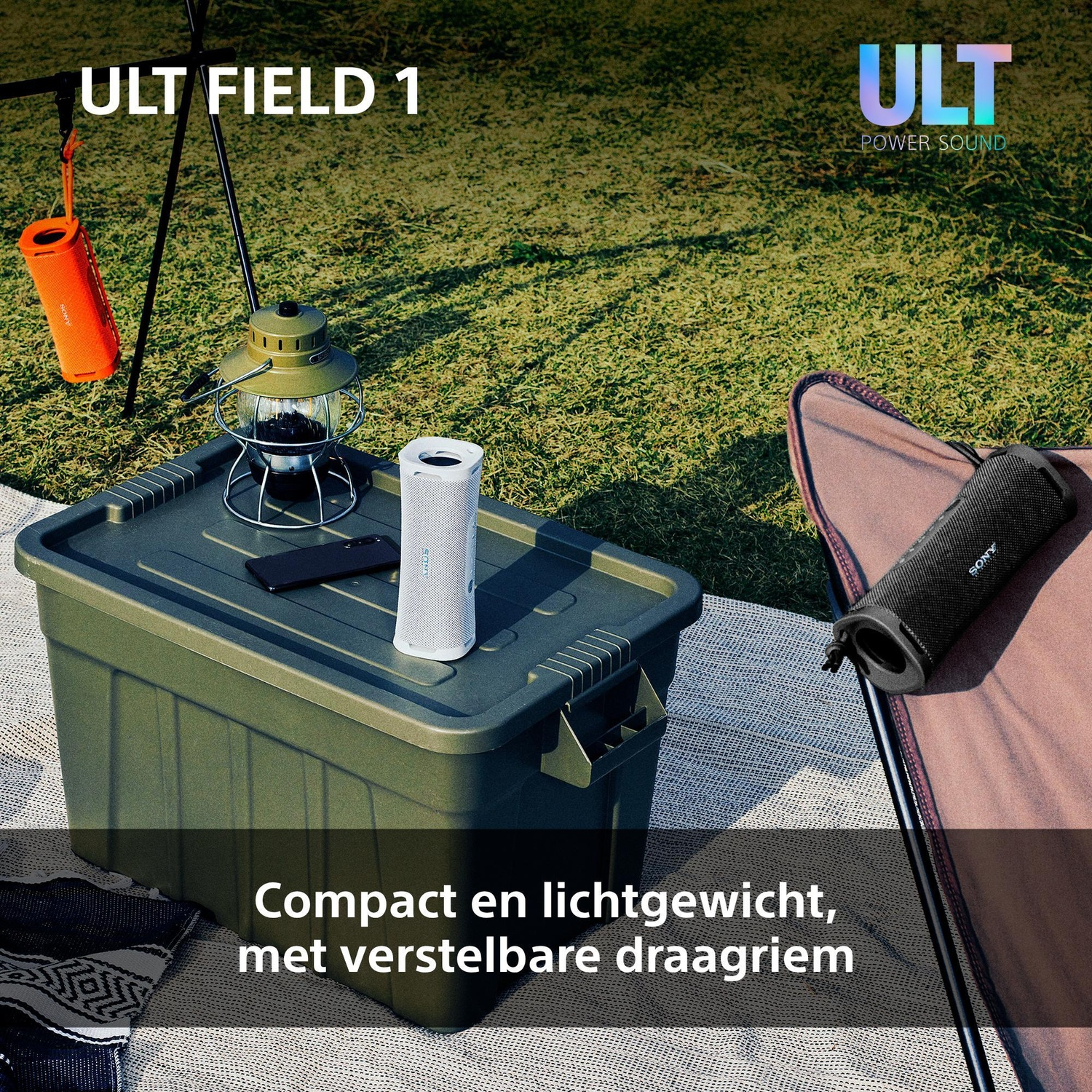 Sony ULT FIELD 1 portable speakers in black, white, and orange on a green camping storage box outdoors.