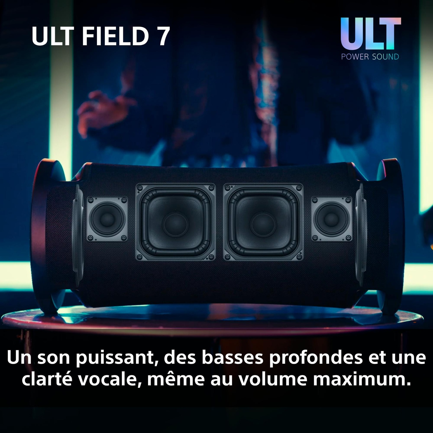 Un haut-parleur sans fil noir sur une surface avec du texte promotionnel en francais, sur fond sombre.