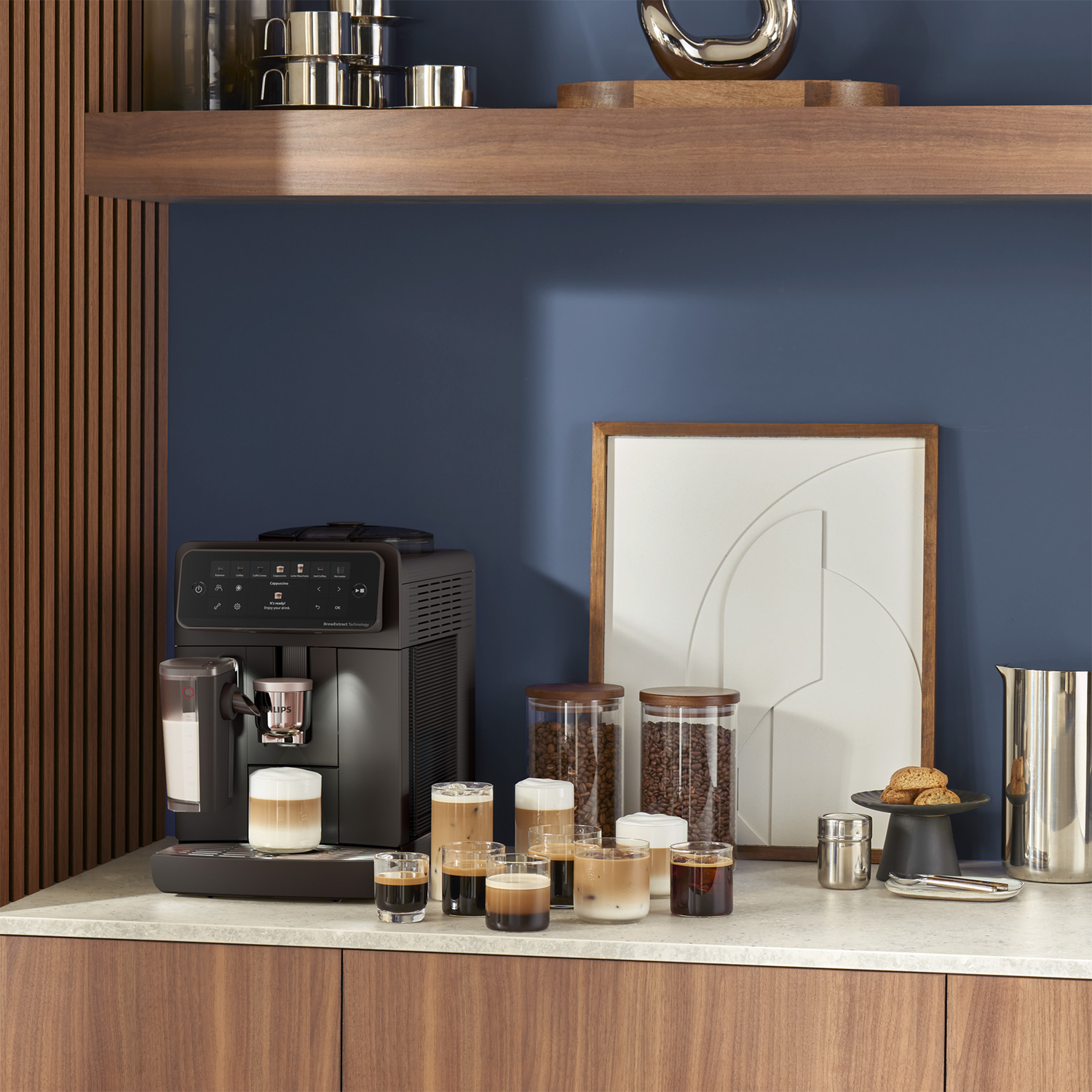 A coffee machine on a kitchen counter with various coffee drinks in glasses and bean storage jars.