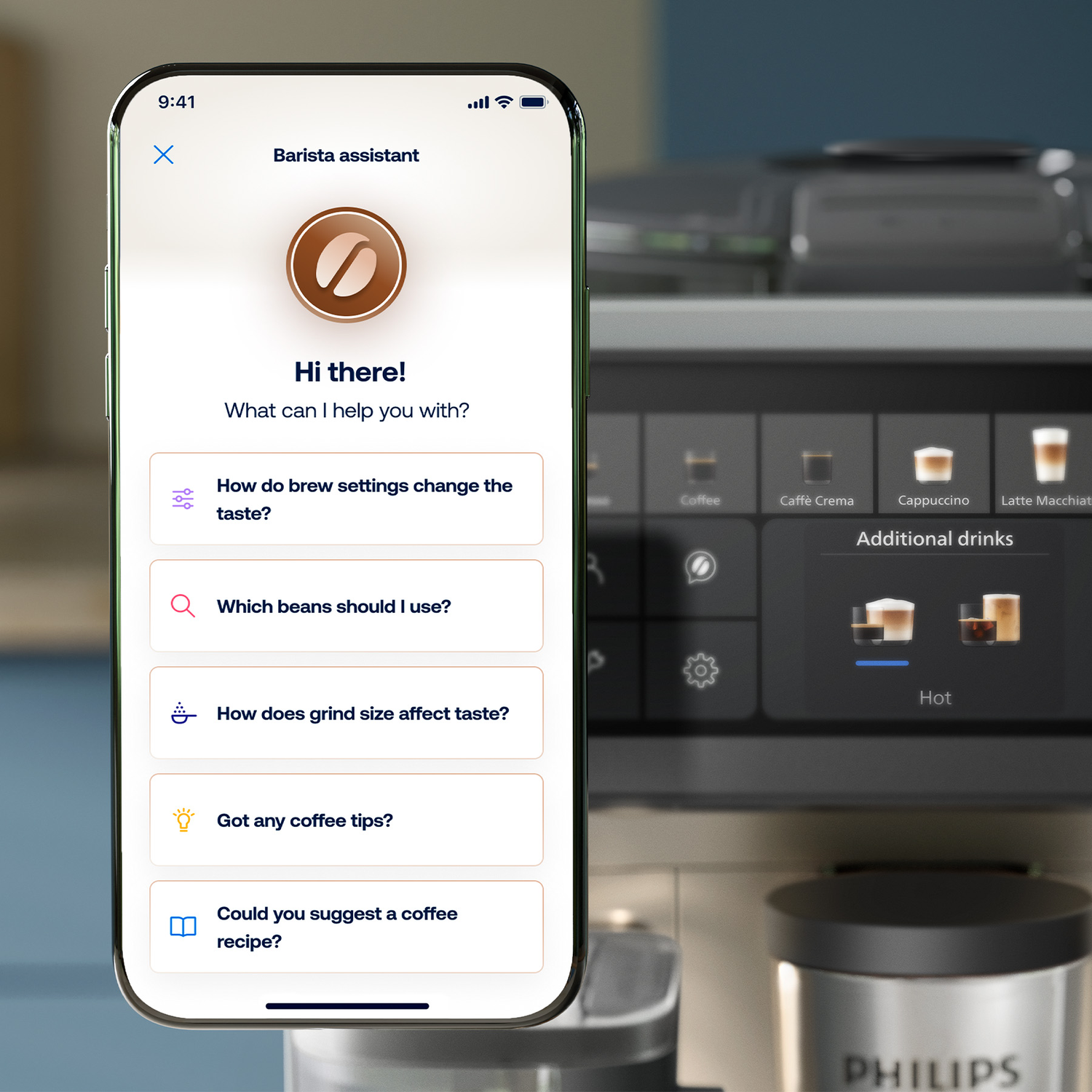 A smartphone displays a coffee app with help options, held in front of a coffee machine.