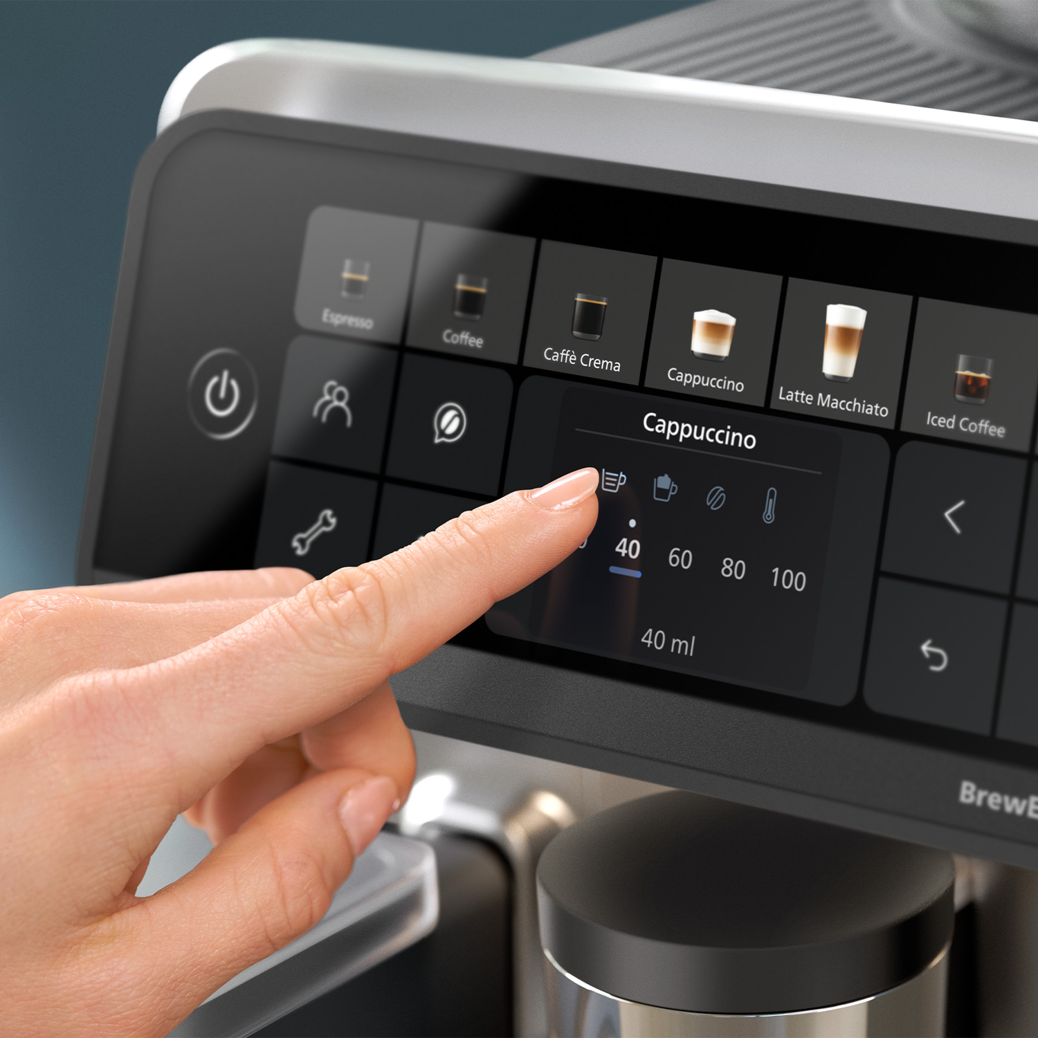 Hand touching the touchscreen of a modern coffee machine displaying beverage options.