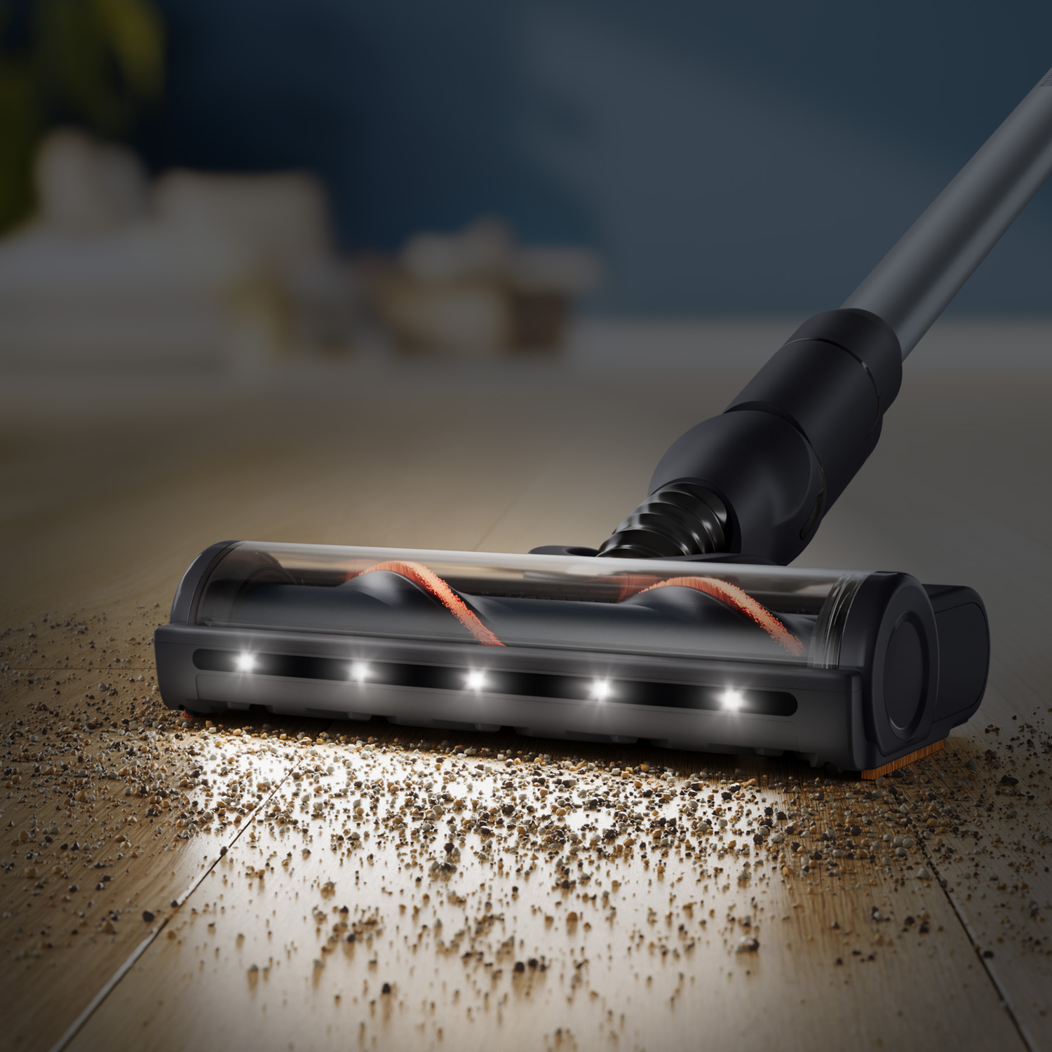 A vacuum cleaner head with LED lights cleans debris from a wooden floor.