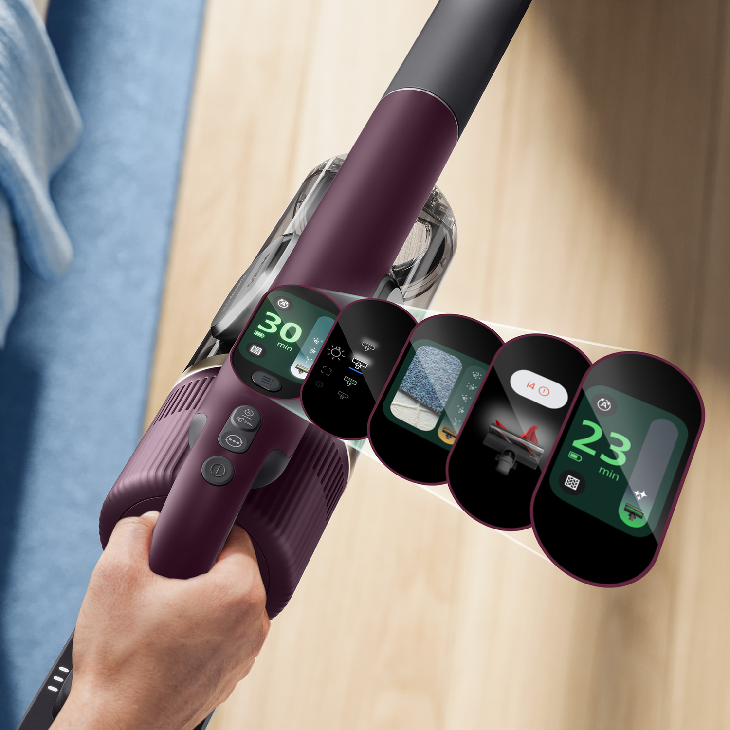 Hand holds a purple cordless vacuum with a digital display showing various menu options.