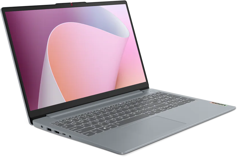 Egy szürke Lenovo laptop világos képernyővel és rózsaszín hullámos háttérrel fekete alapon.