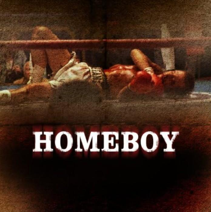 Ein Boxer liegt besiegt im Ring mit dem Wort HOMEBOY darunter.