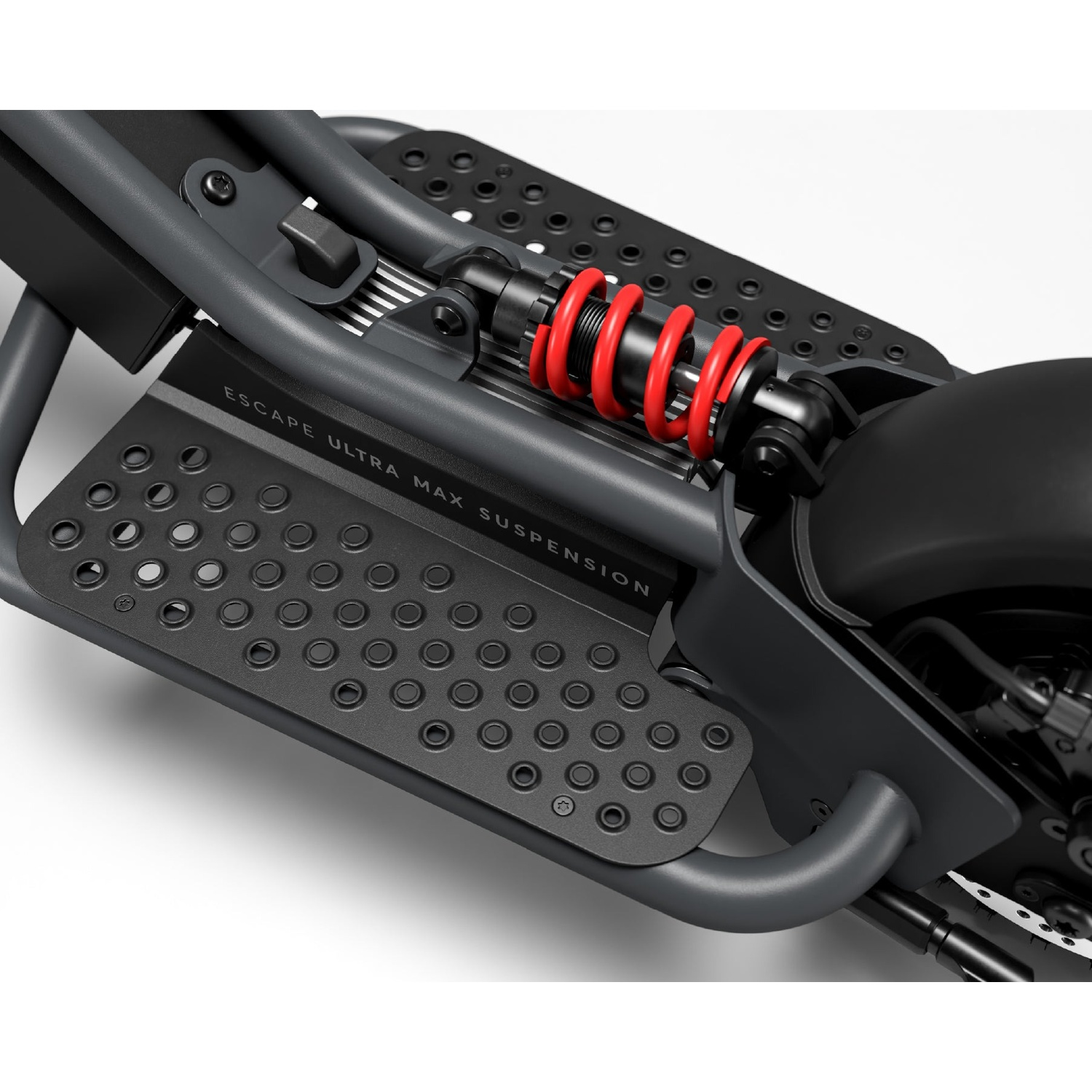 Close-up of a scooter's black frame featuring a bright red suspension spring and perforated footrest.