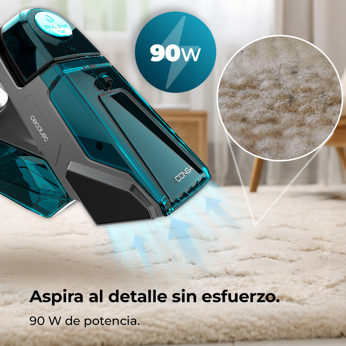 Aspiradora de mano gris y turquesa limpiando una alfombra clara con 90W de potencia.