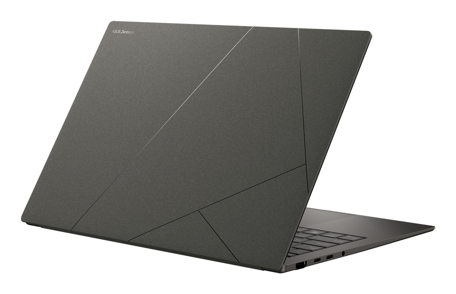 Un ordenador portátil ASUS Zenbook gris cerrado con un patrón de líneas geométricas en la tapa.