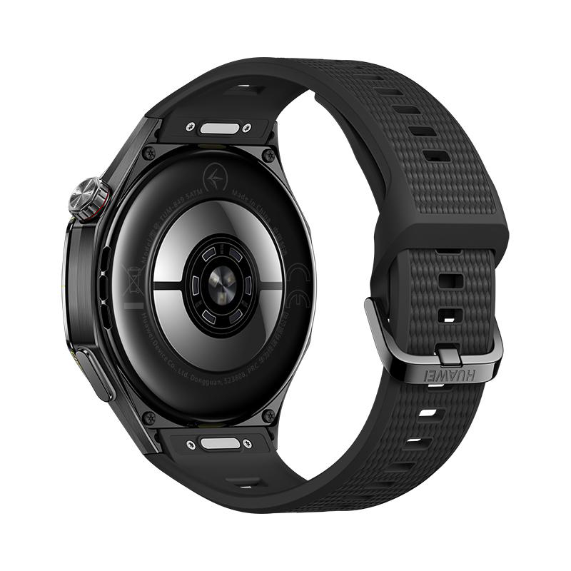 Rückseite einer schwarzen Smartwatch mit Sensorsymbolen und strukturiertem Armband vor weißem Hintergrund.