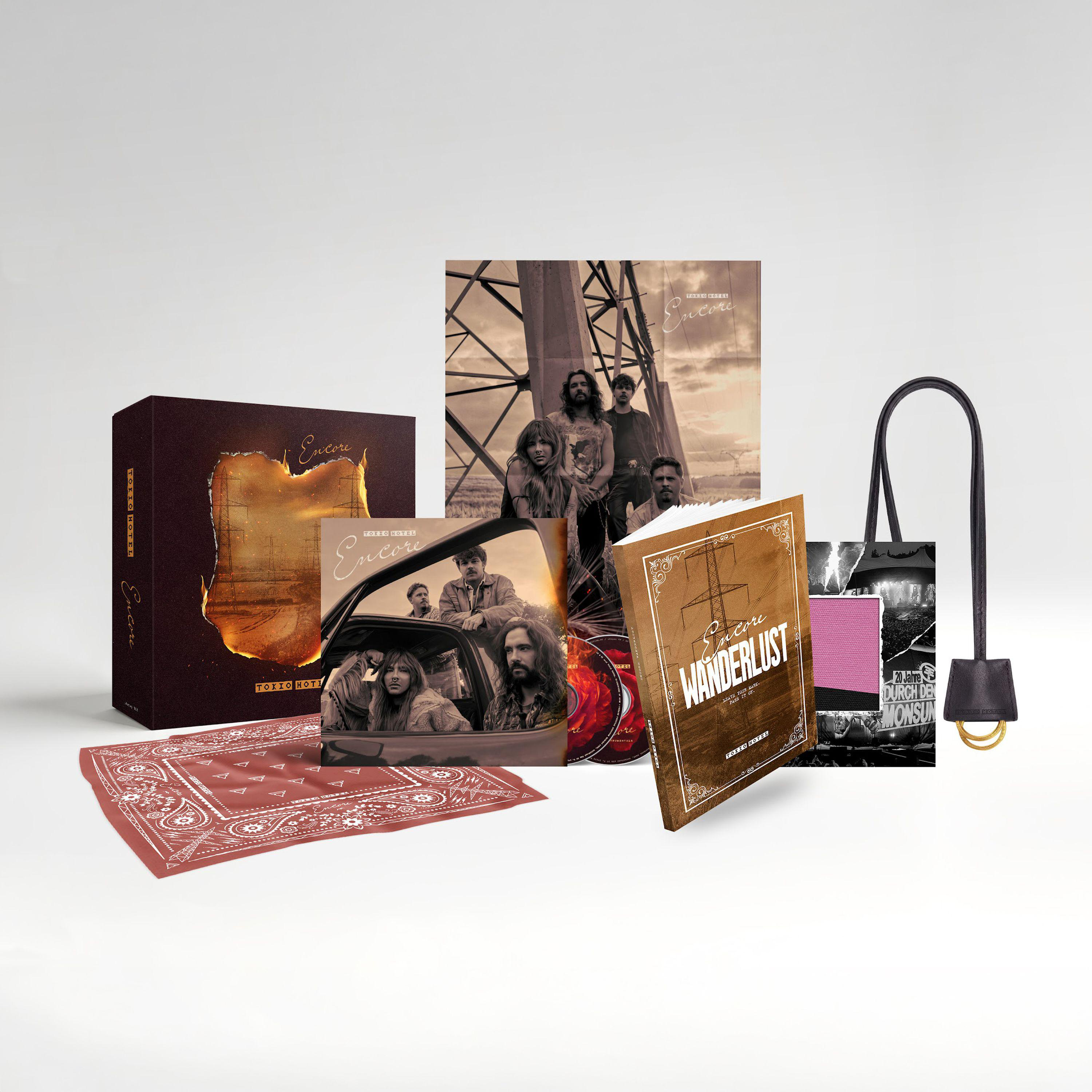 Tokio Hotel Merchandise Box-Set mit Albumcover, Wanderlust-Buch, CDs, rotem Bandana und Tragetasche.
