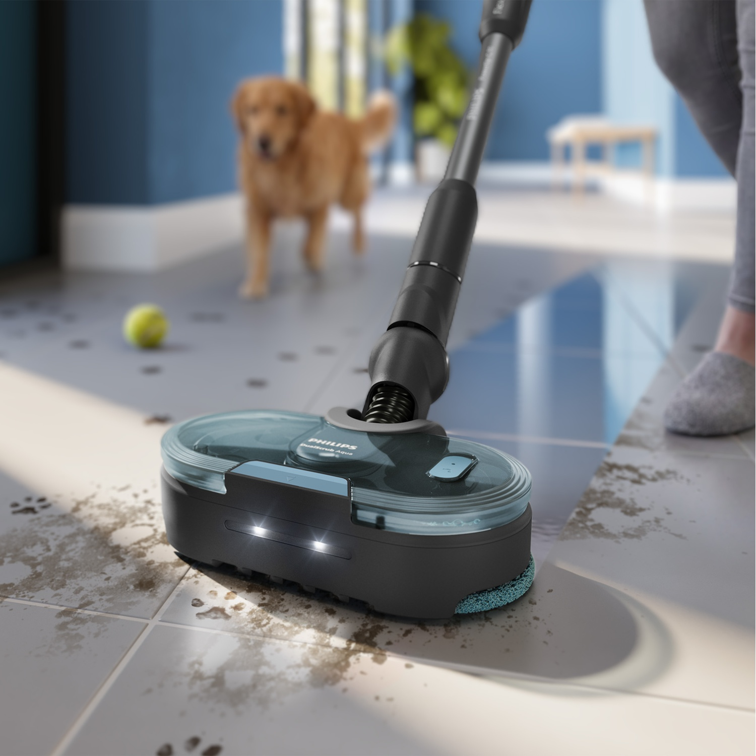 A cordless Philips vacuum cleans dirty tiles with a golden retriever dog standing in the background.