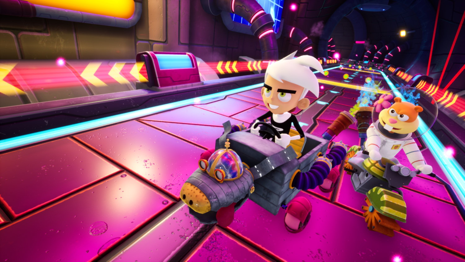 Danny Phantom e Sandy Cheeks guidano kart personalizzati su una pista futurista al neon in un tunnel.