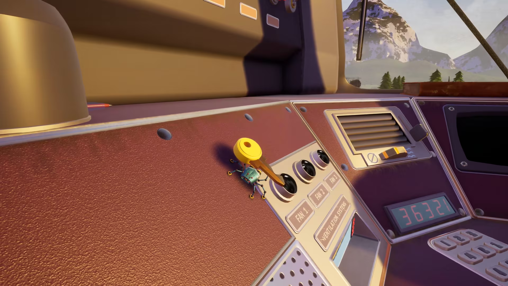 Un interruttore giallo su una console marrone rossastra in una cabina con vista sulle montagne.
