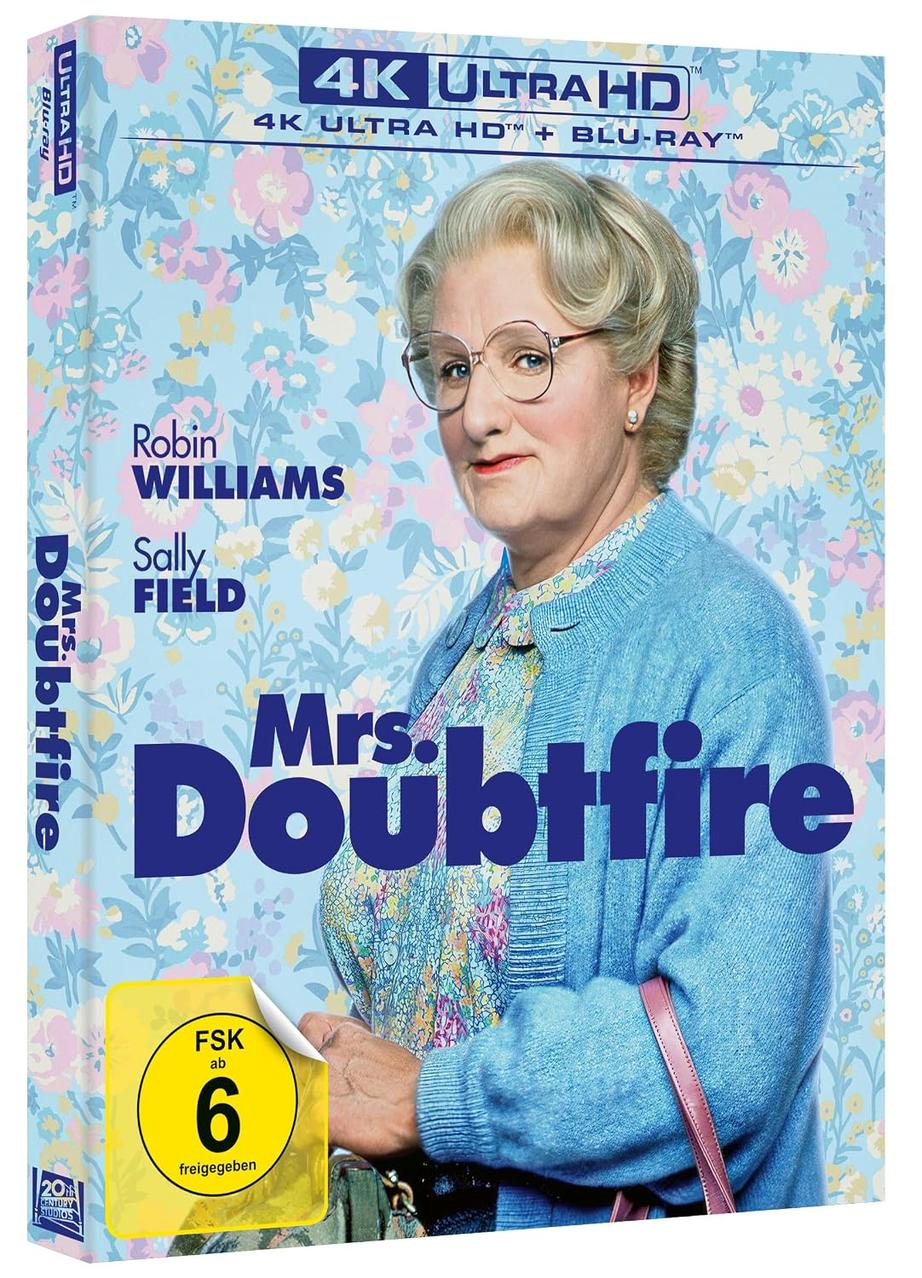 Mrs. Doubtfire 4K Blu-ray Cover mit Robin Williams vor einem blauem Blumenmuster.