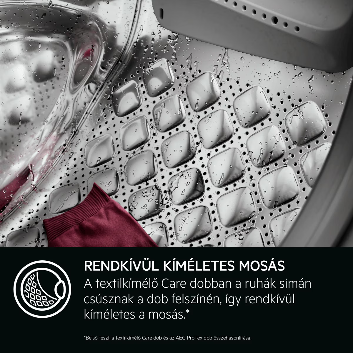 Vizes mosógép dob piros ruhadarabbal és magyar felirattal.