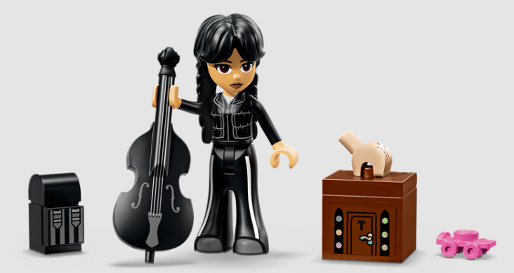 Lego-Minifigur von Wednesday Addams mit schwarzem Cello und Zubehör wie einer Kiste und dem Eisk Händchen.