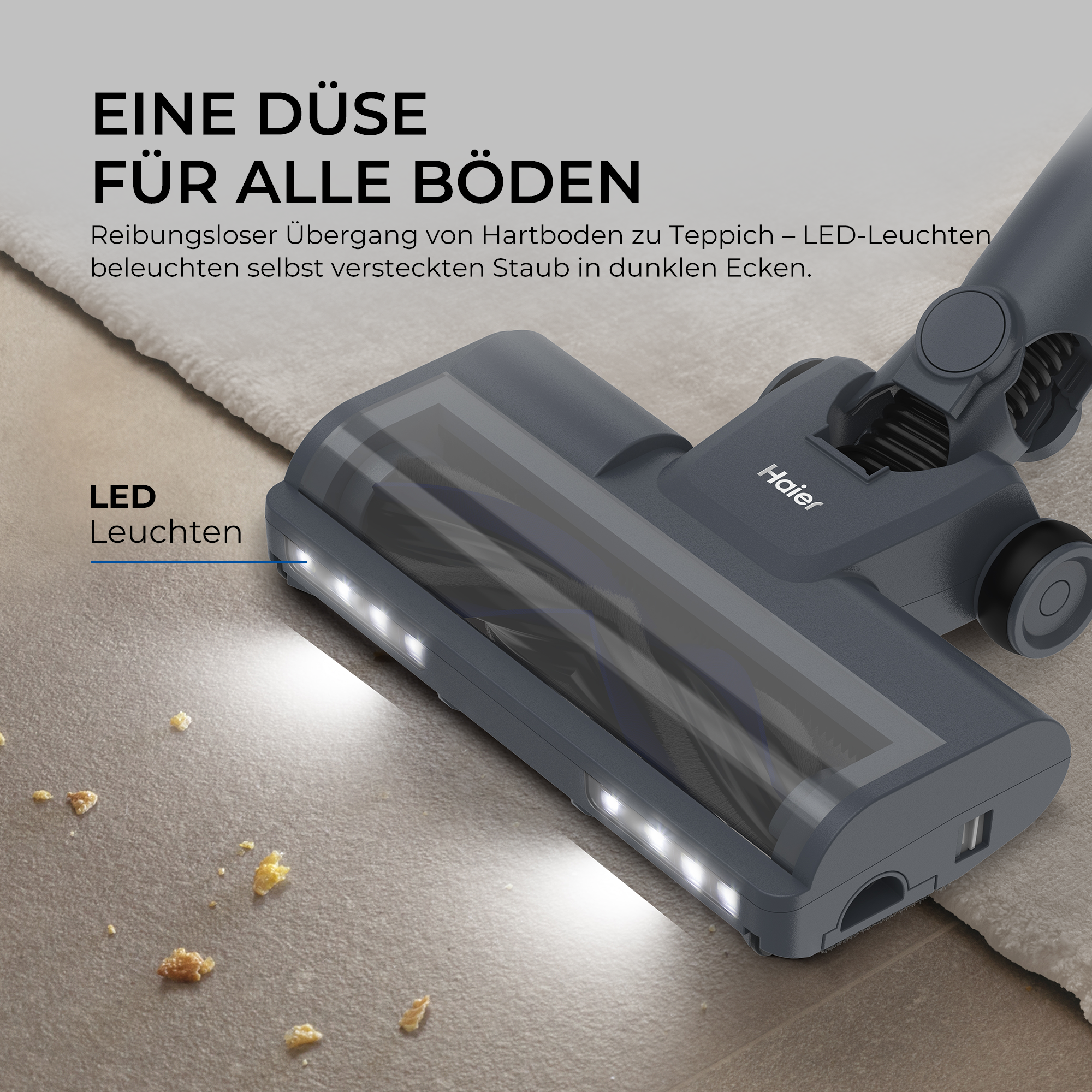 Ein Haier Staubsaugerkopf mit hellen LED-Leuchten beleuchtet Krümel auf Fliesen.