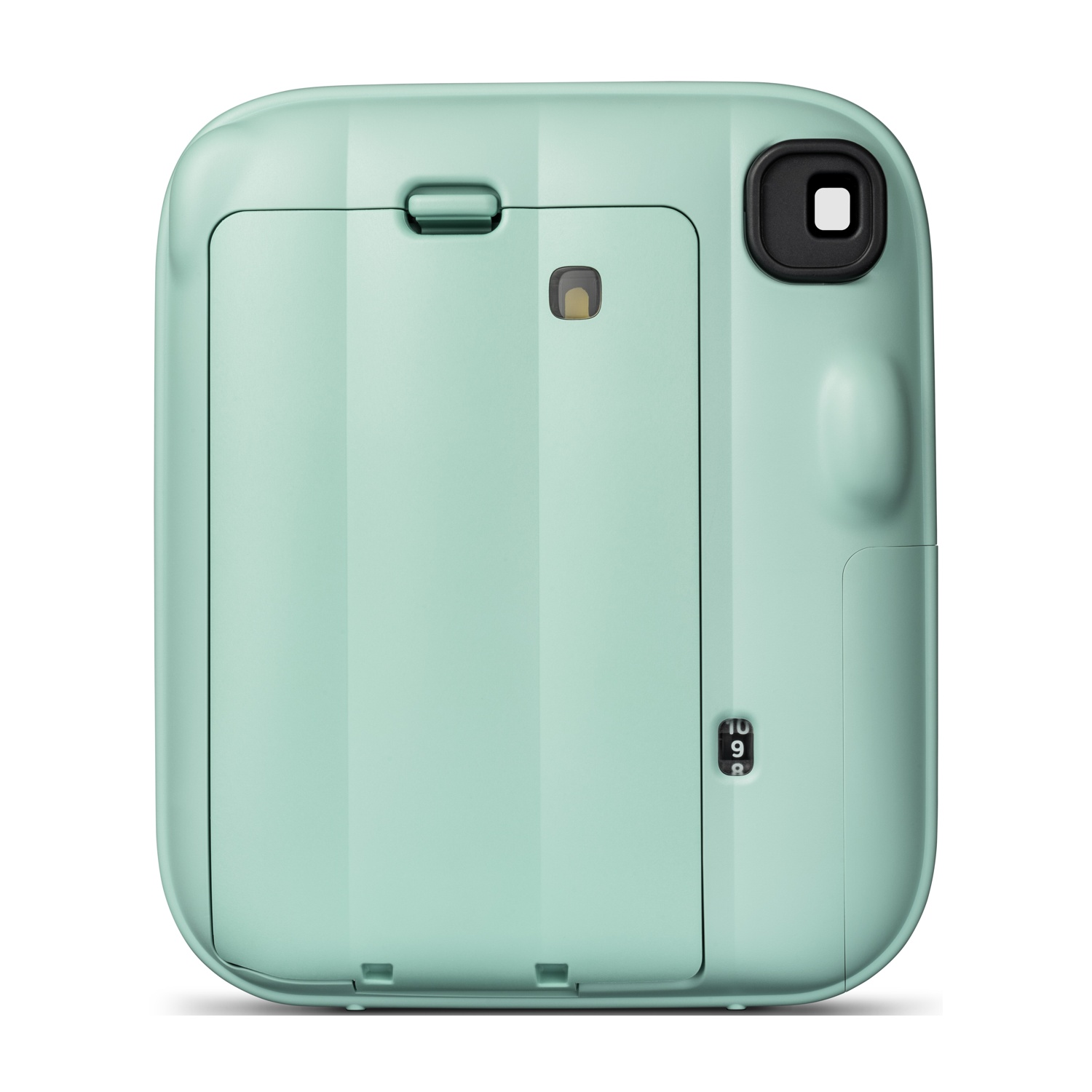Vista posteriore di una fotocamera istantanea verde pastello con un grande sportello per pellicola e un mirino nero.