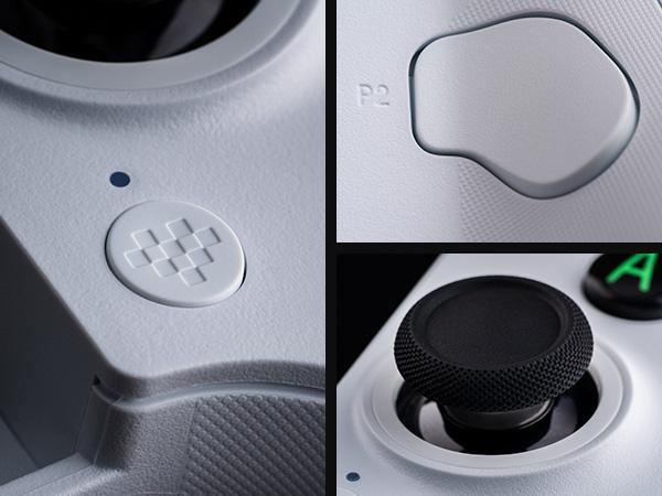 Nahaufnahme eines weißen Controllers mit verschiedenen Tasten, einem Steuerkreuz und einem schwarzen Joystick.