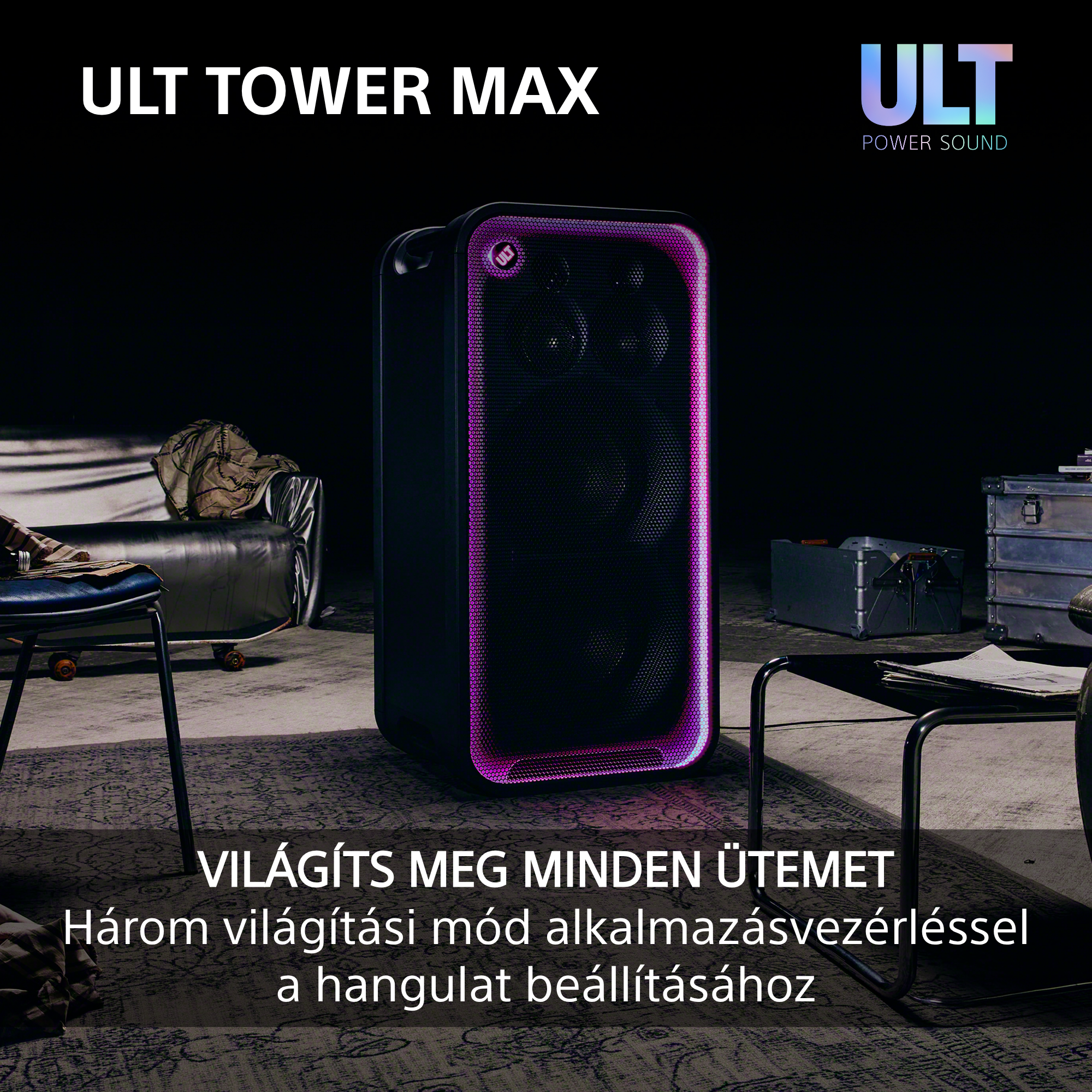 Egy nagy fekete parti hangszóró lila LED világítással áll egy gyengén megvilágított szobában.