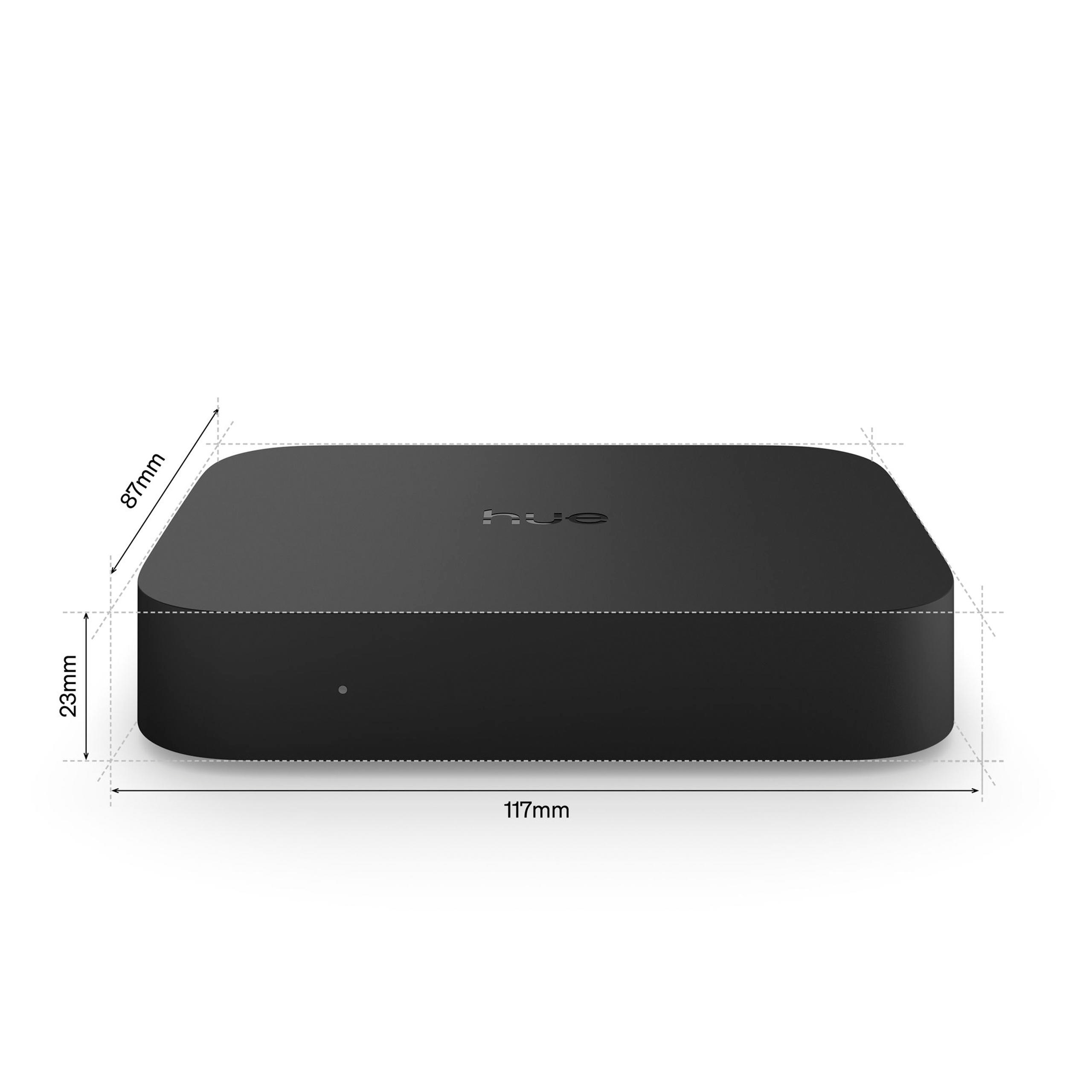 Schwarze Philips Hue Bridge mit Maßen von 117x87x23mm auf weißem Hintergrund.