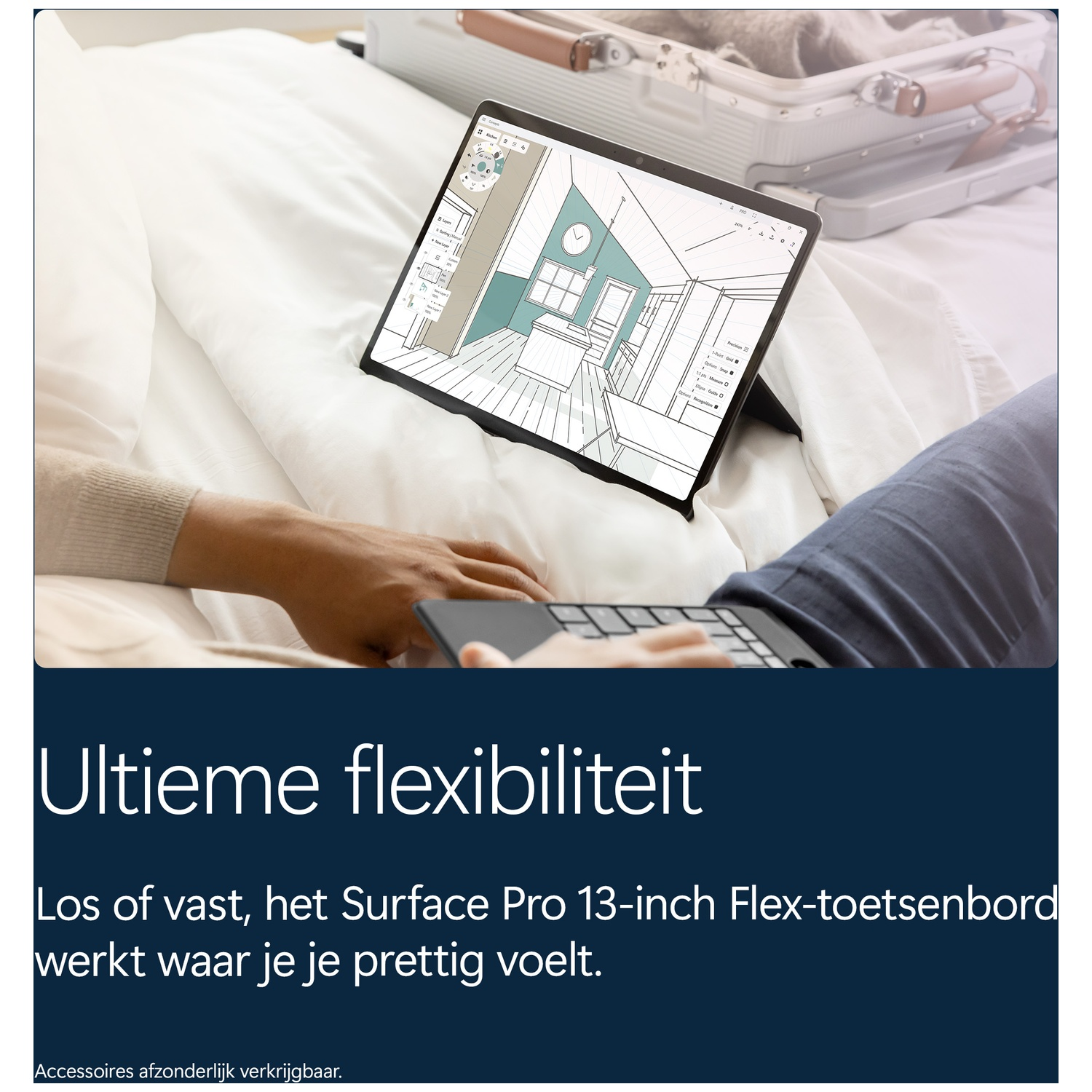 A person uses a Surface Pro with a flexible keyboard on a bed with a suitcase in the background.