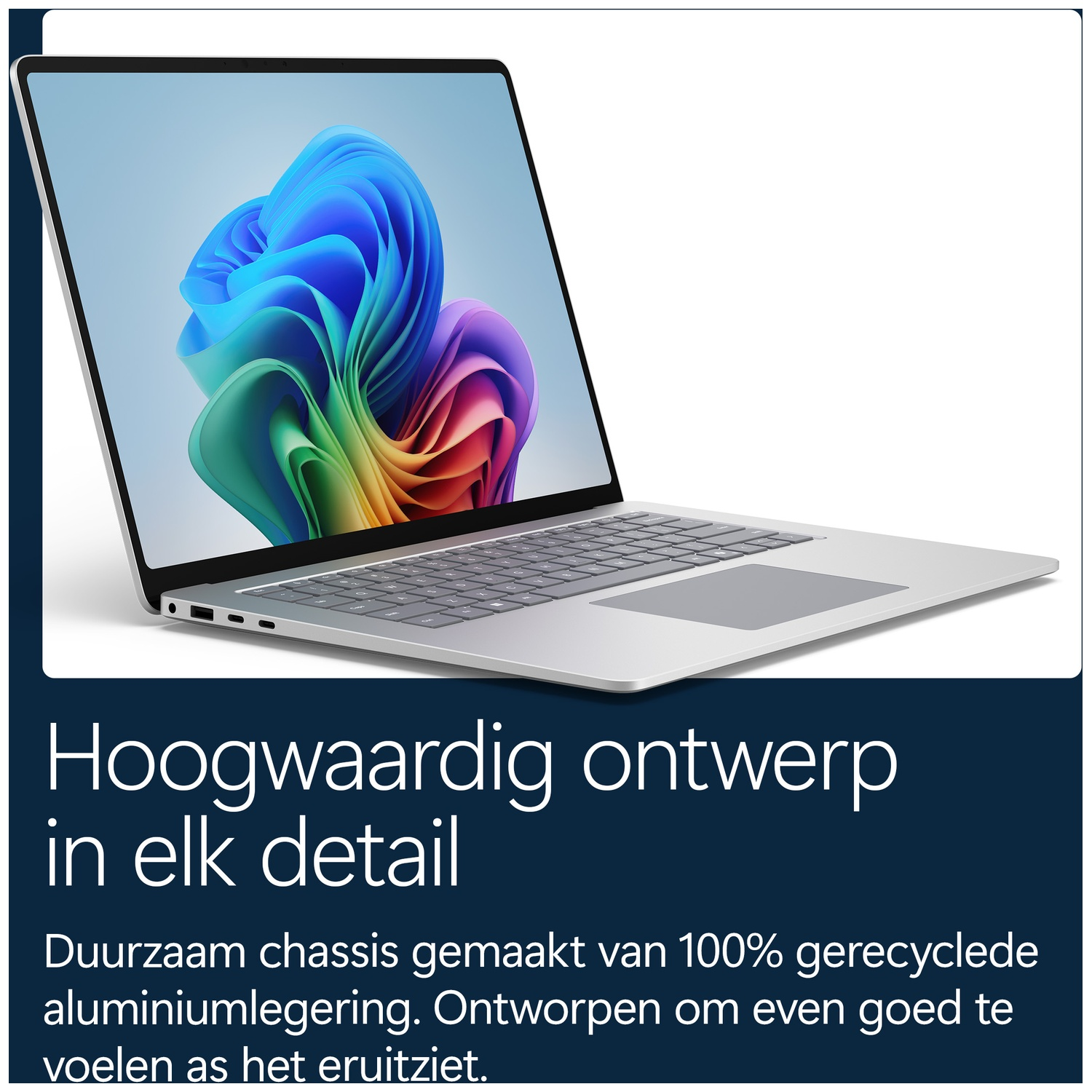 Een zilveren laptop met kleurrijke achtergrond op het scherm, op een wit oppervlak tegen een donkerblauwe achtergrond.