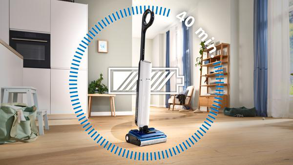 Ein weiß-schwarzer Staubsauger in einem Wohnzimmer mit einer 40-Minuten-Batterieanzeige.