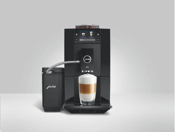 Schwarzer Jura Kaffeevollautomat mit Milchbehälter und Glas Cappuccino auf weißem Hintergrund.
