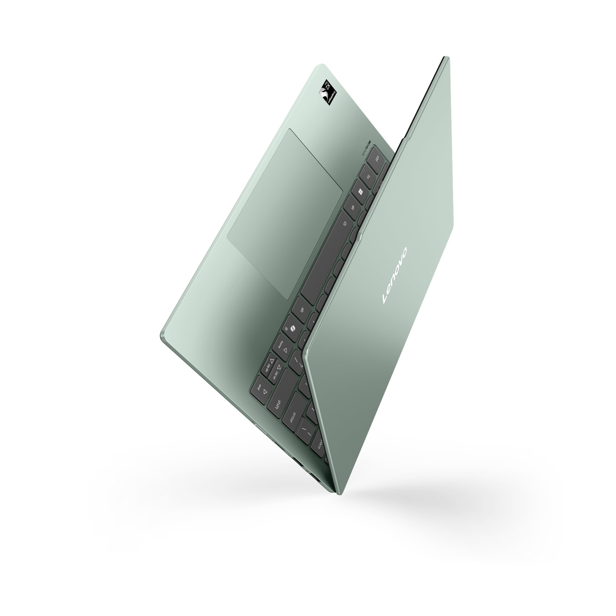 Ein hellgrüner Lenovo Laptop vor schwarzem Hintergrund zeigt Tastatur und geschlossenen Deckel.