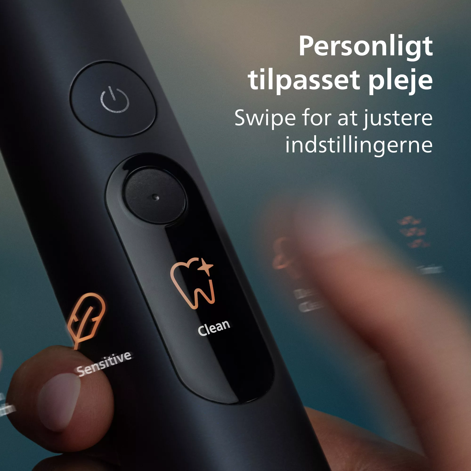Fekete elektromos fogkefe érintőképernyővel és dán nyelvű felirattal.