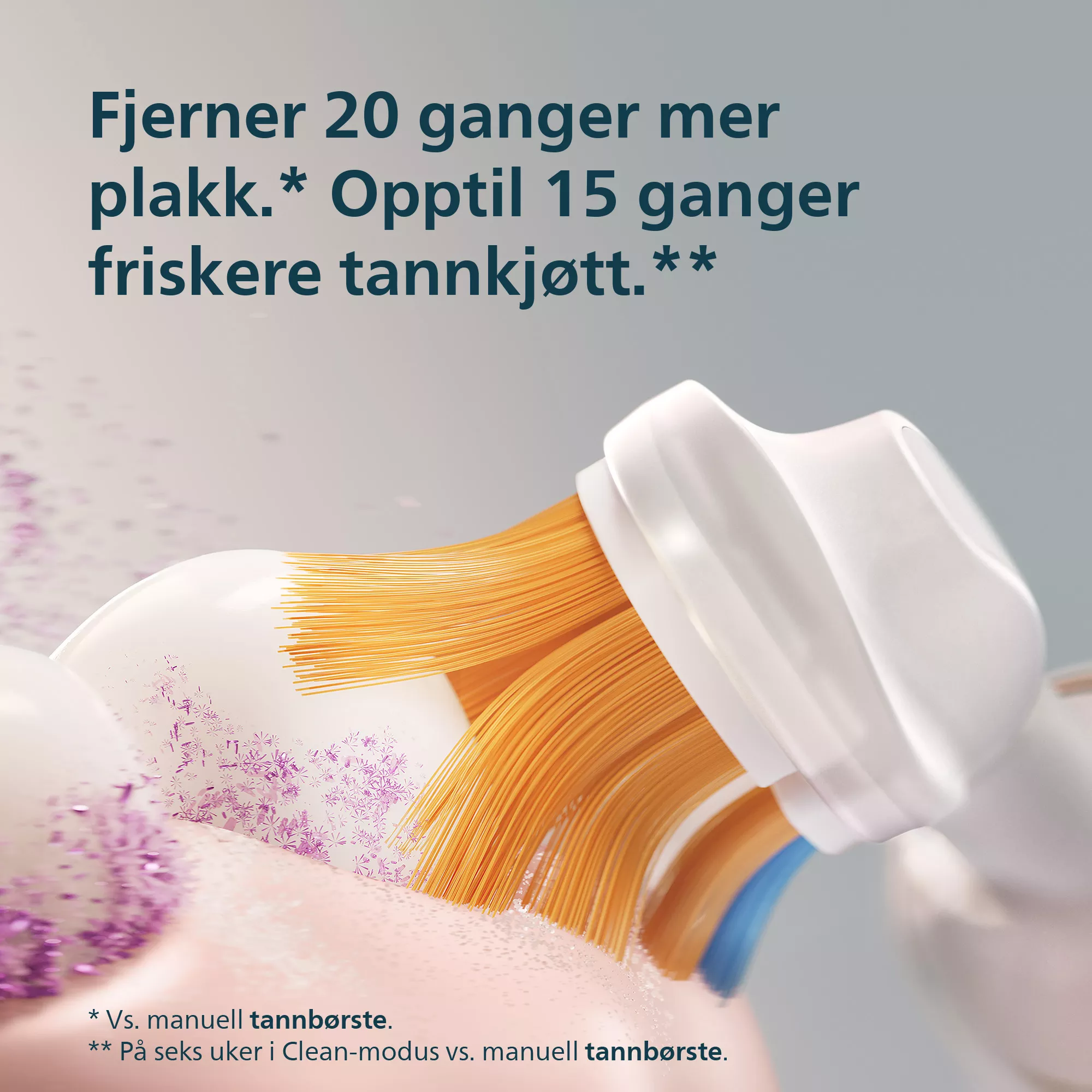 Narancssárga sörtéjű elektromos fogkefefej távolítja el a lila lepedéket szürke háttér előtt.