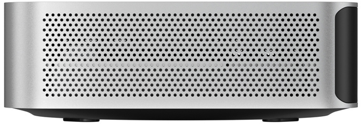 Egy ezüstszínű mini PC elölnézete nagy, téglalap alakú hálós ráccsal és fekete oldalsó elemekkel.