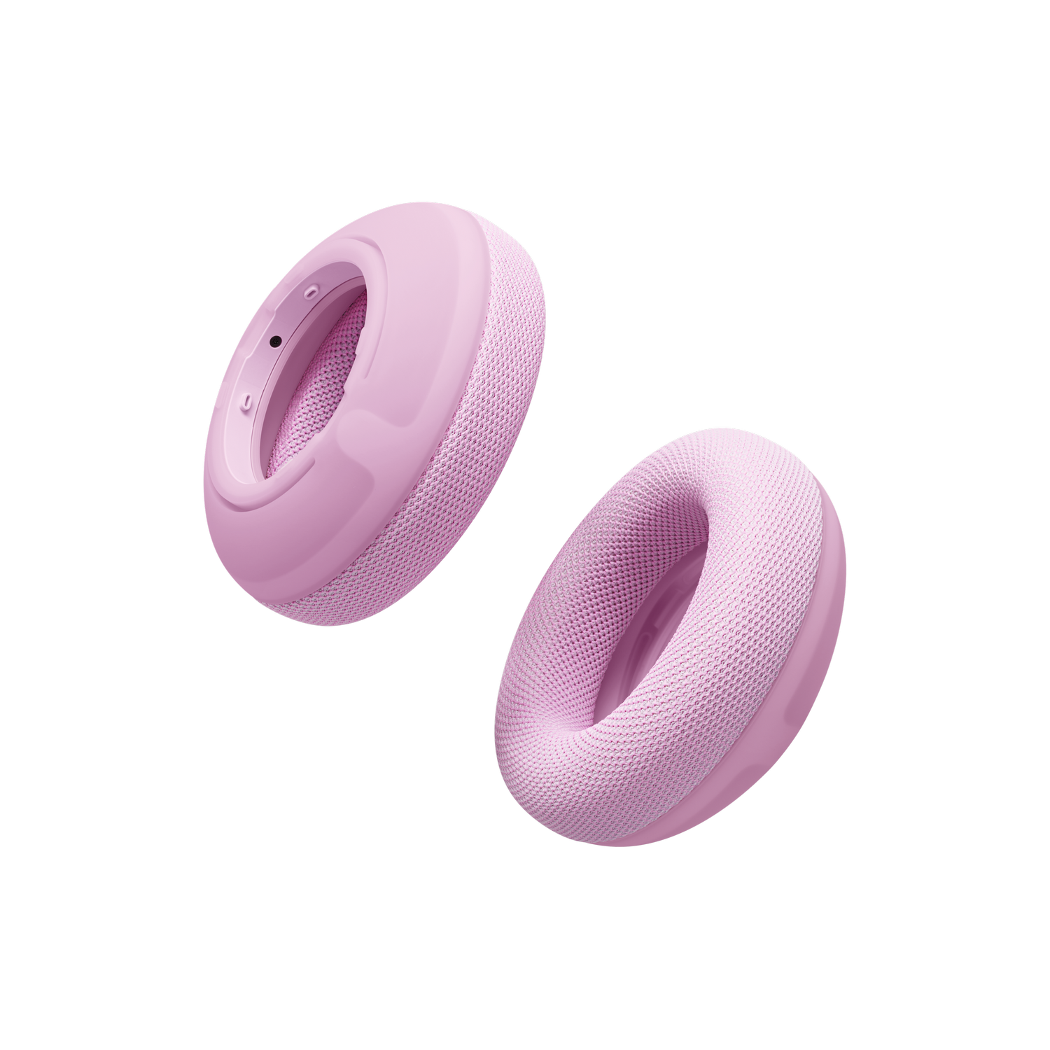 Dos cojines de repuesto para auriculares rosados flotando sobre un fondo negro.