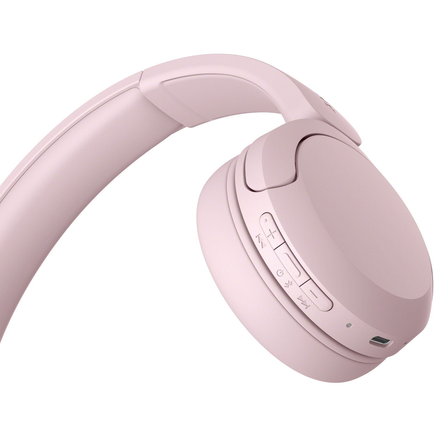 Casque sans fil rose avec boutons de contrôle et port de charge sur l'écouteur sur fond blanc.