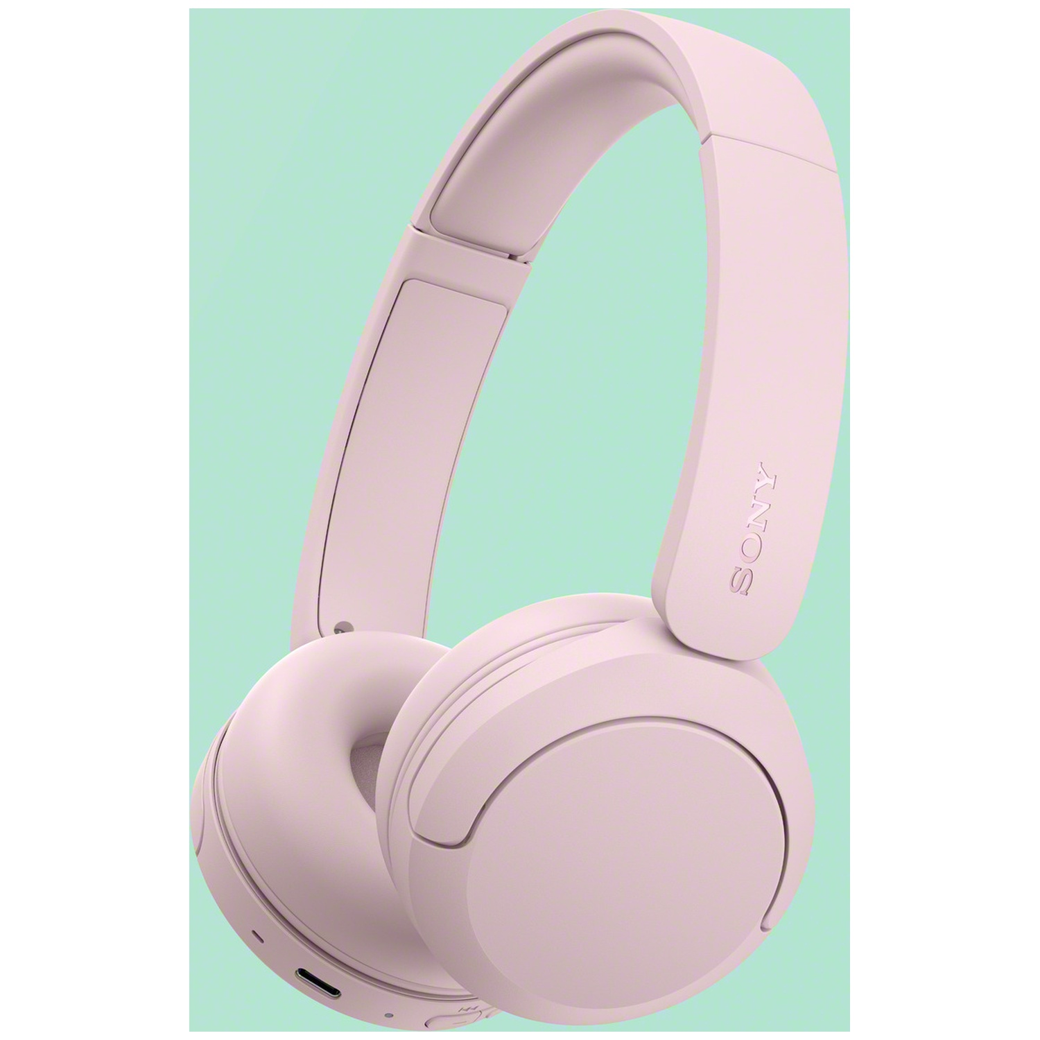 Casque supra-auriculaire Sony rose sur fond vert clair.