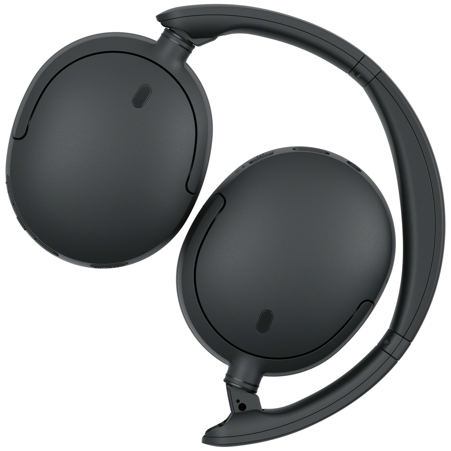 Casque sans fil noir sur fond blanc, disposé pour ressembler à un point d'interrogation.