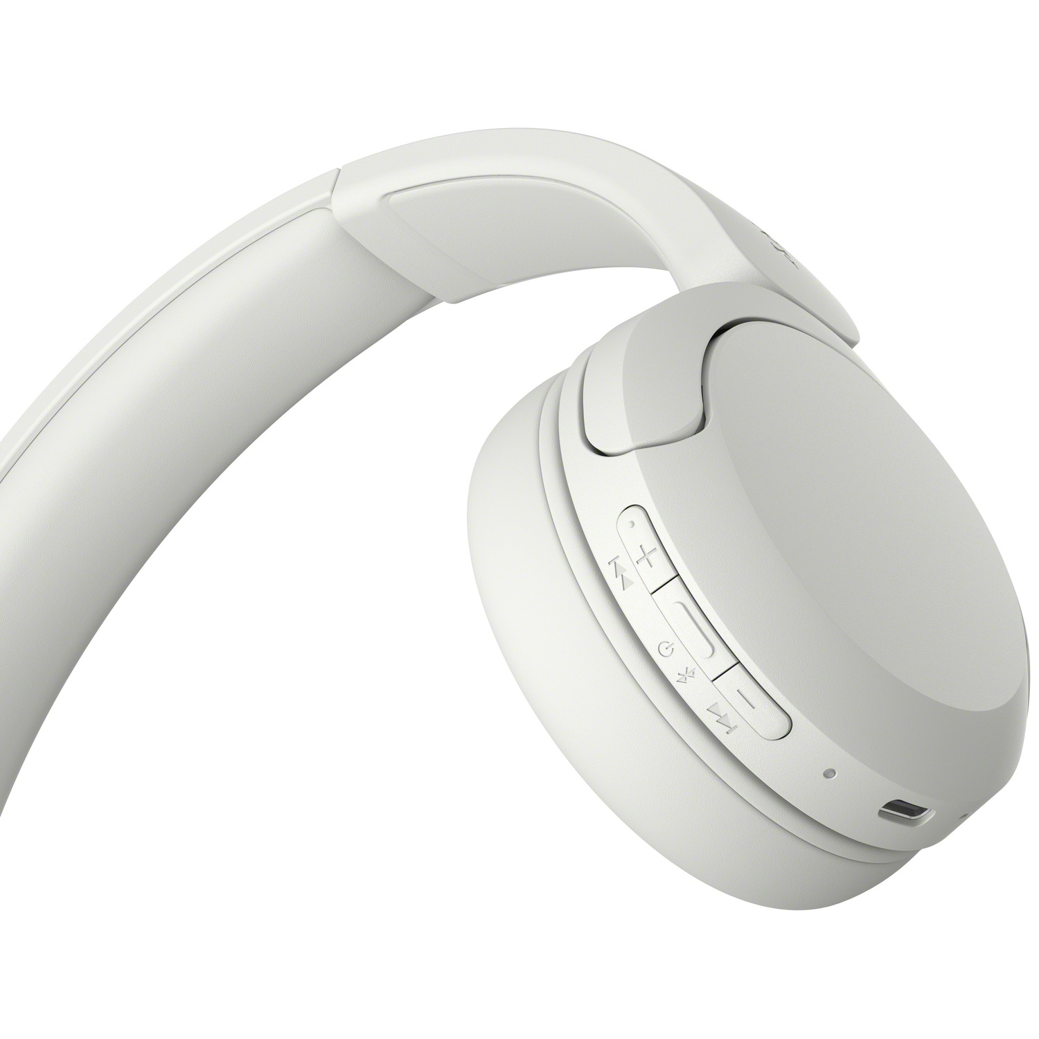 Casque sans fil blanc avec boutons de commande et port de charge sur l'écouteur.