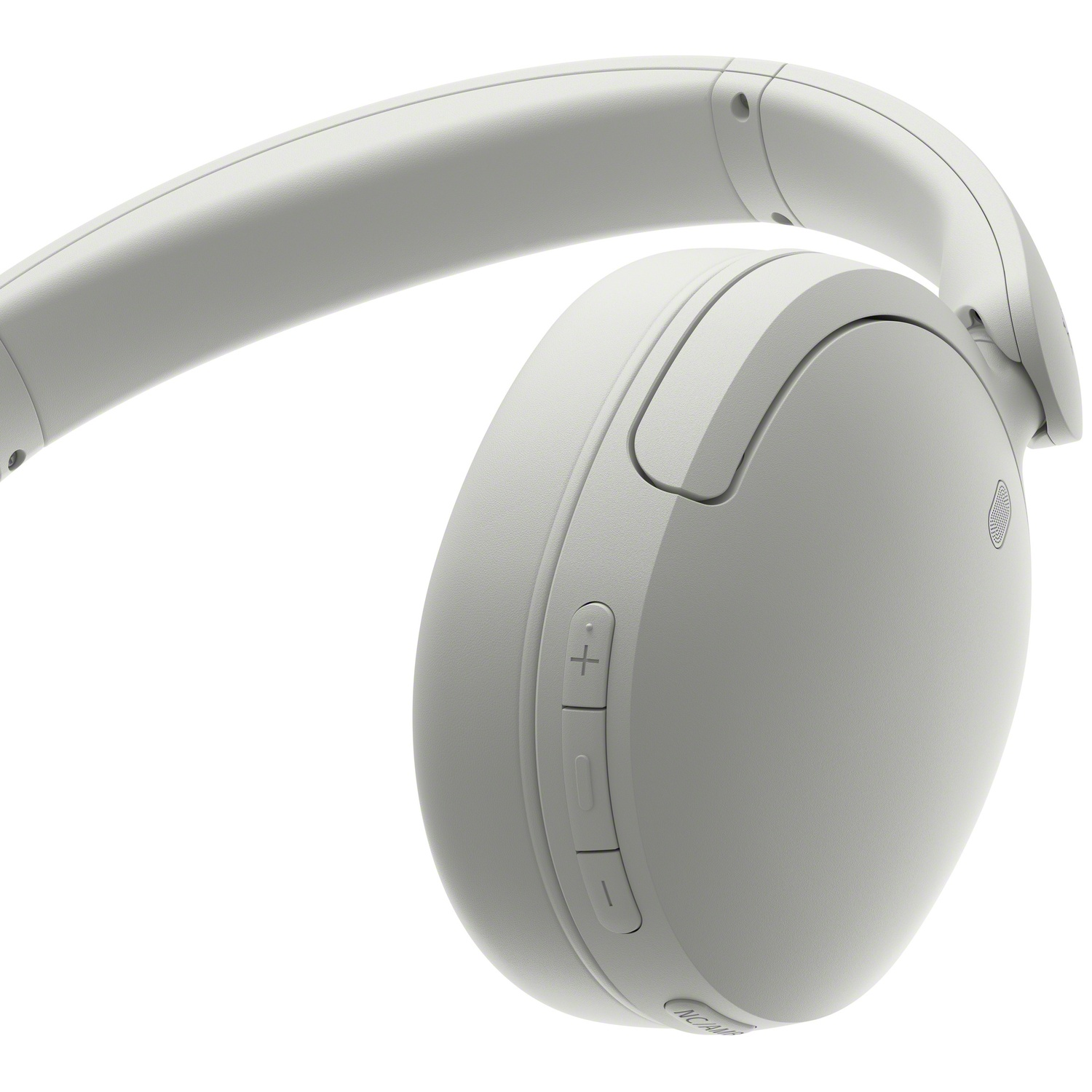 Gros plan d'un casque circum-auriculaire blanc mat avec boutons de volume sur fond blanc.