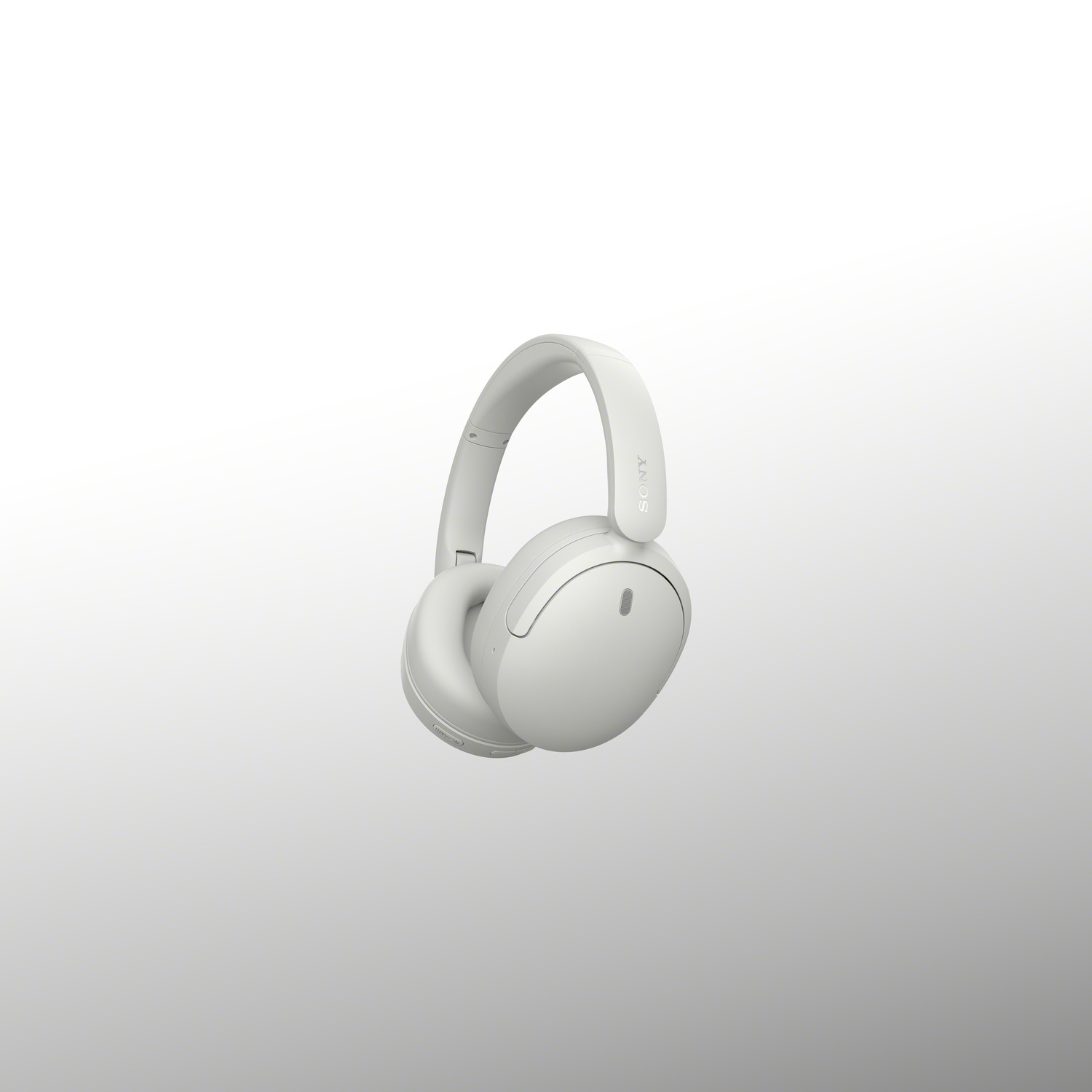 Un casque audio blanc Sony flotte sur un fond clair et uni.